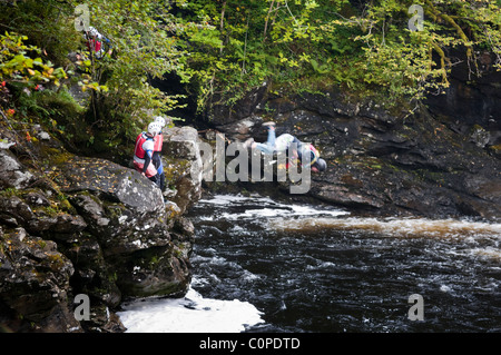 Gorge walking, also known as canyoning at the Falls of Falloch just off the A82 a few miles south of Crianlarich, Scotland Stock Photo