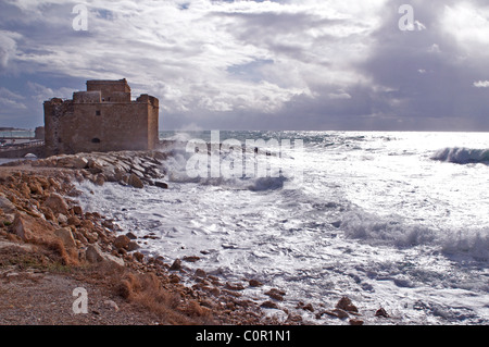 Waves breaking over the rocks and beach at Paphos in Cyprus Stock Photo