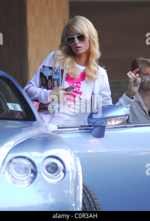 Paris Hilton wearing a monogram T-shirt with her name and a pink Chihuahua dog, leaves her hotel in Hollywood clutching all the Stock Photo