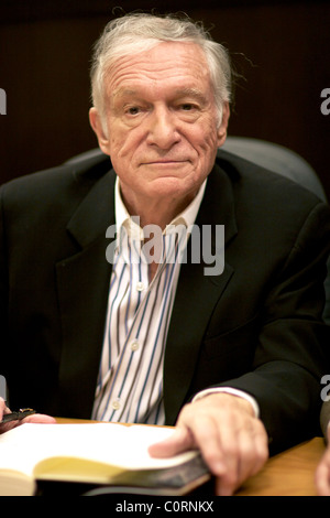 Hugh Hefner signing copies of "Playboy: The Complete Centerfolds" at
