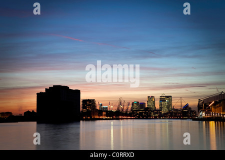 Isle of Dogs, Londons financial centre at dusk reflected in the waters of the Royal Victoria Dock Stock Photo