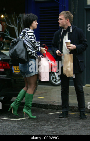 Lily Allen seen out shopping with a male companion, wearing green knee high leather boots and carrying an 'Agent Provocateur' Stock Photo