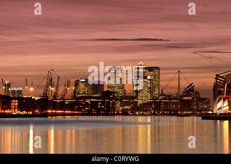 Isle of Dogs, Londons financial centre at dusk reflected in the waters of the Royal Victoria Dock Stock Photo