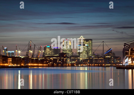 Isle of Dogs, Londons financial centre at dusk reflected in the waters of the Royal Victoria Dock Stock Photo