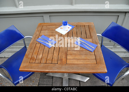 Carluccio's restaurant Islington London table knives forks napkins blue steel paper table wood sugar arrangement Stock Photo