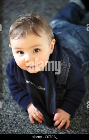 Baby boy, 10 month old, smiling friendly, at home. Stock Photo