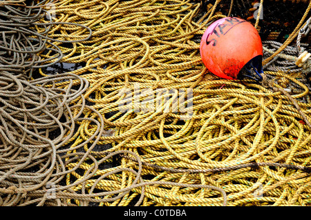 Close up of fishing rope and float  on quayside Stock Photo