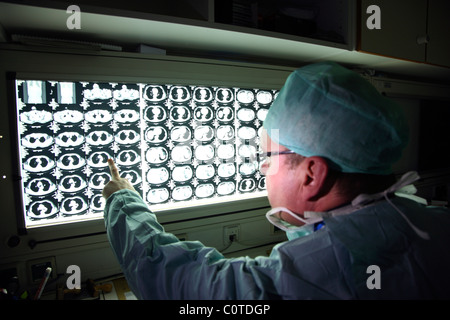 Radiologist, doctor, in a hospital, looks at CT images of a patient. Stock Photo