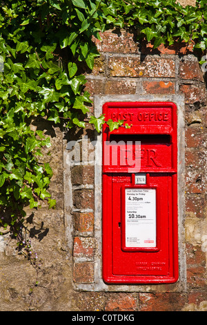 British mail box set in to a stone wall with ivy showing Stock Photo