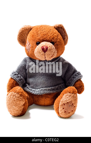 toy teddy brown bear with patches in green sweater isolated on white background Stock Photo