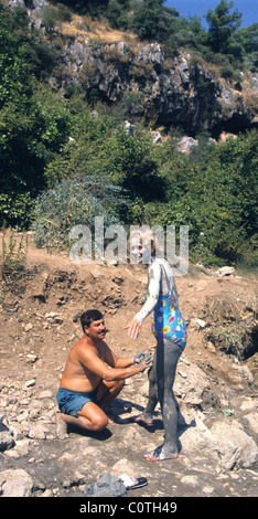 Tourists in Turkey enjoying the mud in the thermal springs near Dalyan.  There are baths at Sultaniye but many like the natural. Stock Photo