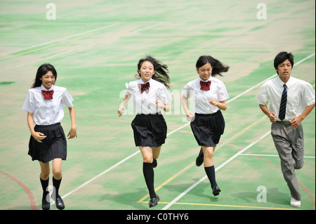 High School Students Running in the Schoolyard Stock Photo