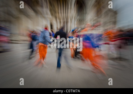 Hare Krishna devotees singing & dancing in St. Mark's square Venice Stock Photo