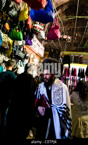 An Orthodox Jewish man wearing a traditional eastern European hat walks through the Muslim quarter in the old city of Jerusalem. Stock Photo