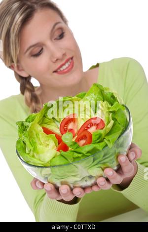 Healthy lifestyle series - Woman with lettuce and tomatoes on white background, focus on salad Stock Photo