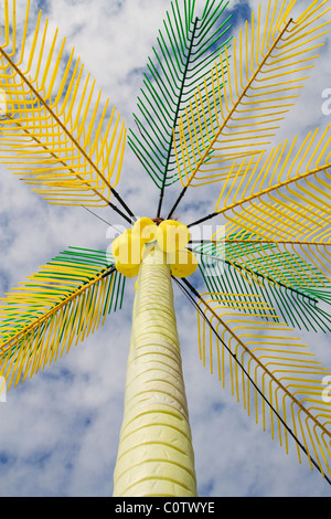 P LASTIC PALM TREE AND COCONUTS ON BEACH IN SPAIN Stock Photo