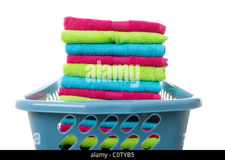 Laundry basket filled with colorful folded towels over white background Stock Photo