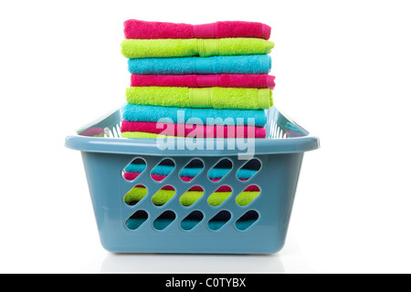 Laundry basket filled with colorful folded towels over white background Stock Photo