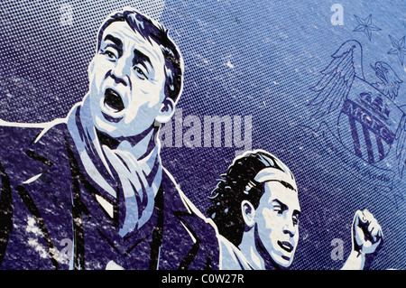 Detail of an artwork outside Manchester City's Etihad football stadium in England showing Roberto Mancini and Carlos Tevez Stock Photo