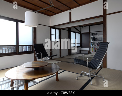Contemporary tatami room in a japanese living room with C. Eames office lounge chairs Stock Photo