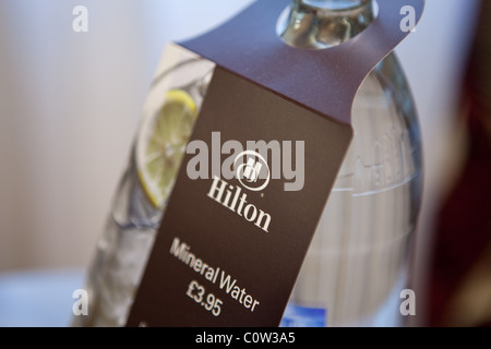 a bottle of mineral water in a Hilton hotel room Stock Photo