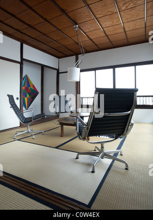 Contemporary tatami room in a japanese living room with C. Eames office lounge chairs Stock Photo