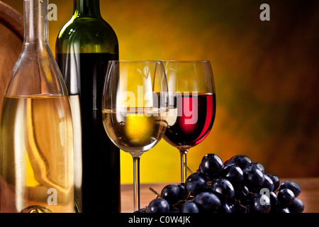 Still life with wine bottles, glasses and oak barrels. Stock Photo