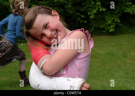 Little girl with two broken arms Stock Photo