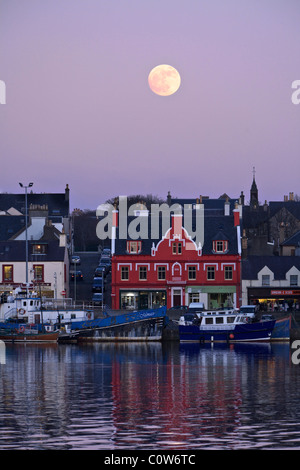 Stornoway Harbour with full moon at dusk. Stock Photo