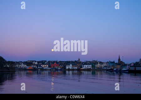 Stornoway Harbour with full moon at dusk.
