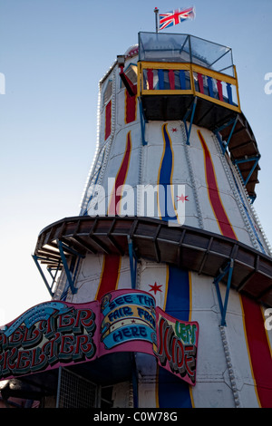 Funfair ride on Brighton Pier against a blue sky Stock Photo