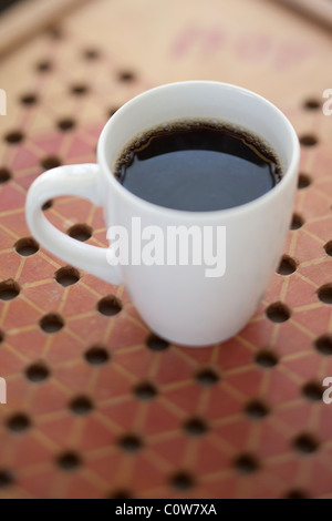 fresh coffee in white cup on game board Stock Photo