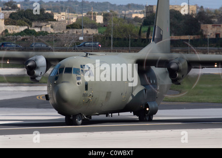 RAF Lockheed Martin C-130J Hercules military transport plane lining up on the runway for departure. Close up front view with emphasis on propellers. Stock Photo