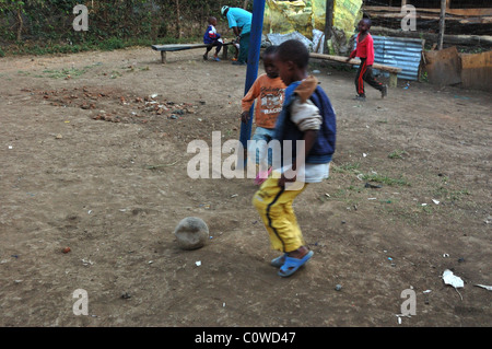 Orphan children playing football/soccer in the town of Usa River near Arusha Tanzania Stock Photo