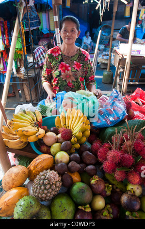 Woman selling tropical fruit in the public market in Ubud Bali Indonesia Stock Photo