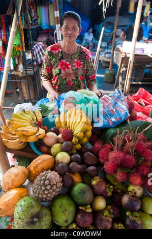 Woman selling tropical fruit in the public market in Ubud Bali Indonesia Stock Photo