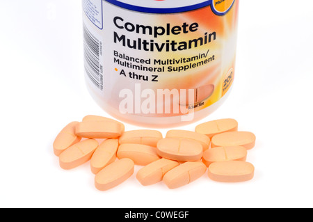 Bottle of Multivitamins with tabs scattered on white background Stock Photo