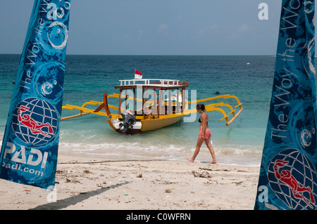 Brightly painted glass bottomed dive boat on the beach at Gili Trawangan a small island off Lombok, Indonesia Stock Photo