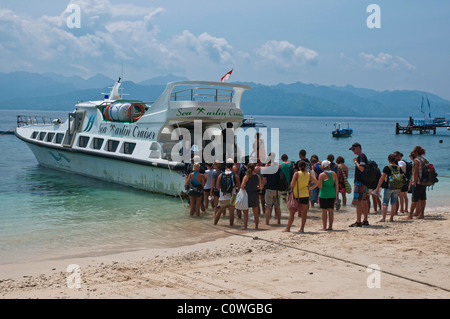 Tourists boarding one of the high speed boats at Gili Trawangan off Lombok for the one and a half hour trip to Bali Stock Photo