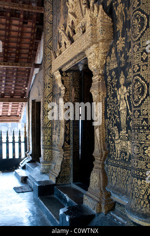 Stencilled gold-leaf motives at the entrance of the Main temple or Sim, Wat Xiang Thong, Luang Prabang, Laos Stock Photo