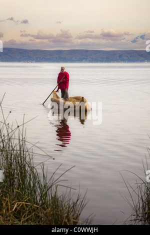 Bolivian man in traditional costume in reed boat on Lake Titicaca, Bolivia, South America. Stock Photo