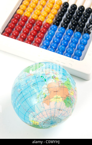 World and Abacus. A ball textured with world map and a simple wkite abacus on white background Stock Photo