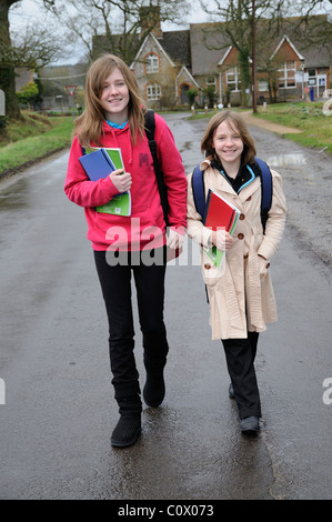 Schoolchildren walking from school along a country lane England UK Stock Photo