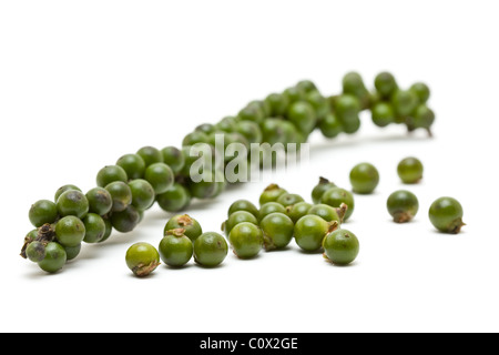 Unprocessed fresh green peppercorns over white background Stock Photo