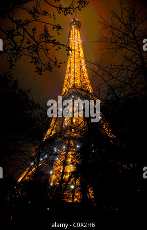 The Eiffel Tower lit up at night in Paris, France. Stock Photo