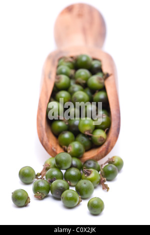 Unprocessed fresh green peppercorns in wooden scoop Stock Photo