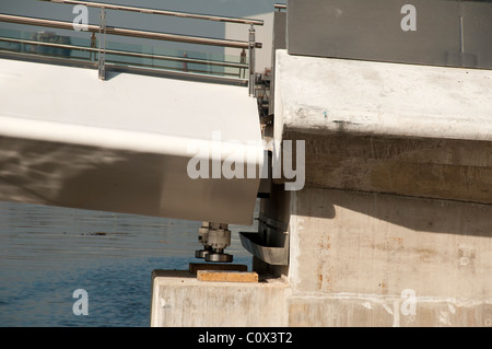 The MediaCityUK swing footbridge, Salford Quays, Manchester, UK. The hydraulic jacks will lift the bridge to the correct height. Stock Photo