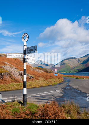 Signpost by Wastwater near Greendale in the Lake District National Park, Cumbria, England. Great Gabel and Lingmell fells are in the distance. Stock Photo