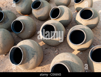 Hand made indian water pots drying in the sun before firing. Andhra Pradesh , india Stock Photo