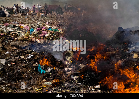 Nicaraguan garbage recollectors work among the burning piles of garbage in the garbage dump La Chureca, Managua, Nicaragua. Stock Photo